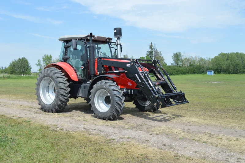 URSA tractor with front-end loader outdoors